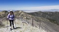 A Hiker Makes Her Way to the Summit of a Mountain