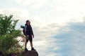 Hiker man with backpack standing on top of the mountain Royalty Free Stock Photo
