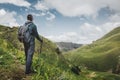 Hiker Man With Backpack And Trekking Poles Resting And Looking At The Mountains In Summer Outdoor, Rear View Royalty Free Stock Photo