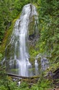 Hiker man in far distance pointing at massive waterfall Royalty Free Stock Photo