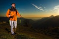 Hiker man practice nordic walking at sunset in the hills Royalty Free Stock Photo