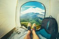 Hiker Man Sitting In A Tourist Tent by The Elbrus Mount Travel Discovery Concept. View Of Legs. Point Of View Shot Royalty Free Stock Photo