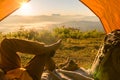 Hiker Man Sitting In A Tourist Tent by Travel Discovery Concept. Royalty Free Stock Photo