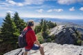Hiker man standing at the rock edge on top of the mountain. Royalty Free Stock Photo