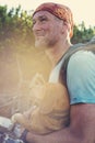 Hiker stands on a mountain trail with a funny small dog Royalty Free Stock Photo