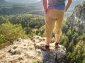 Hiker man stays on the mountain hill during hiking.