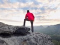 Hiker man take a rest on mountain peak. Man lay on summit, bellow autumn valley Royalty Free Stock Photo