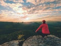 Hiker man take a rest on mountain peak. Man lay on summit,