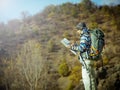 Hiker with map exploring wilderness on trekking adventure