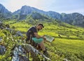 The Hiker with a Map in Mountains