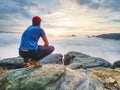 Hiker in middle of nowhere and thinking alone. Man sit on top