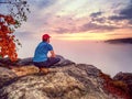 Hiker in middle of nowhere and thinking alone. Man sit on top