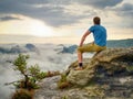 Hiker in middle of nowhere and thinking alone. Man sit on top