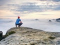 Hiker in middle of nowhere and thinking alone. Man sit on top