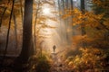 hiker on a misty morning in the autumn forest, with the sun breaking through the trees Royalty Free Stock Photo