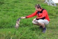 Hiker in the mountains with a curious marmot Royalty Free Stock Photo