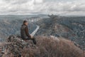 Hiker on a mountainside. Panorama of the South Ural taiga at dawn