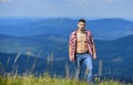 Hiker muscular torso reach mountain peak. Hiking concept. Man stand top mountain landscape background. Athlete guy relax Royalty Free Stock Photo