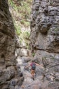 Hiker in a narrow trail of Imbros gorge, Crete Greece Royalty Free Stock Photo