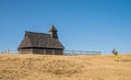 Hiker near raditional wooden church on Velika Planina