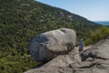 Hiker Next To The Bubble Rock. The Bubble Rock Is A Glacial Erratic Located Near The Summit Of South Bubble In Acadia National