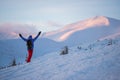 Hiker, with open arms, stands on the mountain range Royalty Free Stock Photo