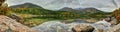 Hiker overlooking Basin Pond with autumn leaves