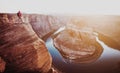 Hiker overlooking Horseshoe Bend at sunset, Arizona, USA Royalty Free Stock Photo