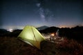 Hiker Overlooking Milky Way By The Fire Nearby Illuminated Tent