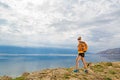 Hiker with pack overlooking Adriatic Sea, Rab Island, Croatia