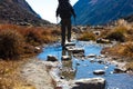 Hiker passing Mountain Creek stepping on Stones Royalty Free Stock Photo