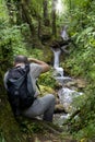 Hiker photographing waterfall