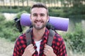 Hiker portrait. Male hiking man happy and smiling during hike trek. Beautiful young sporty model joyful