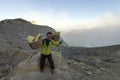 Hiker posing as sulphur miner at Kawah Ijen volcano