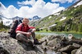 Hiker is posing at camera in mountains of Altai