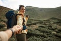 Hiker with radio set smiling while being in the mountains