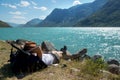 hiker resting on backpack near Gjende lake in Jotunheimen National