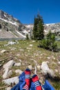 Hiker rests her feet, showing USA American flag themed hiking socks, while resting at Lake Solitude in Grand Teton National Park Royalty Free Stock Photo