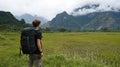 Hiker in rice paddy, mountains Royalty Free Stock Photo