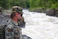 Hiker rocky shore of a mountain river.