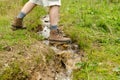 Hiker`s feet in a brook Royalty Free Stock Photo