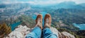 Hiker s feet on mountain summit admiring breathtaking view of lake and river landscape
