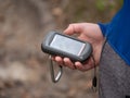 Hiker searching cache using global positioning device