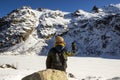 A hiker seating in front of the frozen Melu lake, Corsica.