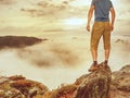 Hiker on sharp cliff of sandstone rock in rock empires park