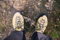 Hiker shoes on dirt autumn footpath in forest on hiking trip