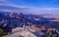 Hiker sitting at edge of rock outcrop with panoramic view of the Grand Canyon Royalty Free Stock Photo