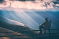 Hiker sitting on a wooden fence. Instagram stylisation Royalty Free Stock Photo