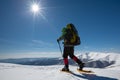 Hiker snowshoeing in winter mountains during sunny day Royalty Free Stock Photo