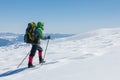 Hiker snowshoeing in winter mountains during sunny day Royalty Free Stock Photo